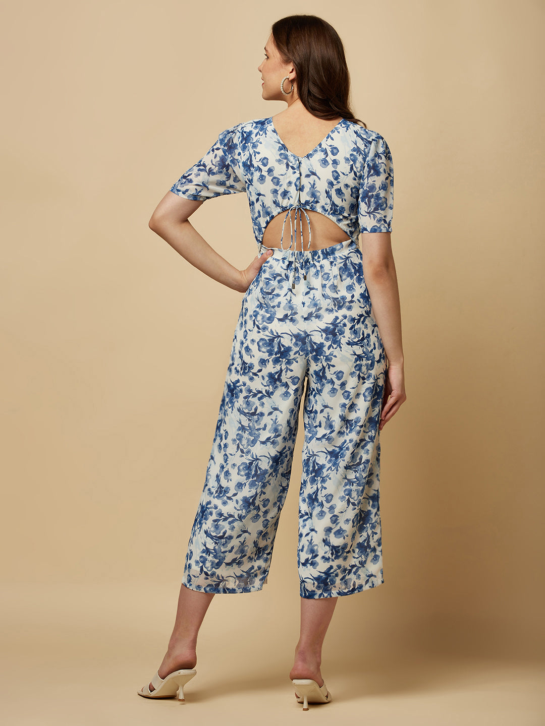 Introducing our stunning Blue Printed Women Jumpsuit With Back Waist Cut and Draw String, the perfect addition to your wardrobe for a stylish and comfortable look. Crafted from high-quality materials, this jumpsuit is both soft and durable, making it perfect for all-day wear. The back waist cut adds a touch of elegance to the design, while the drawstring ensures a perfect fit that flatters your figure.