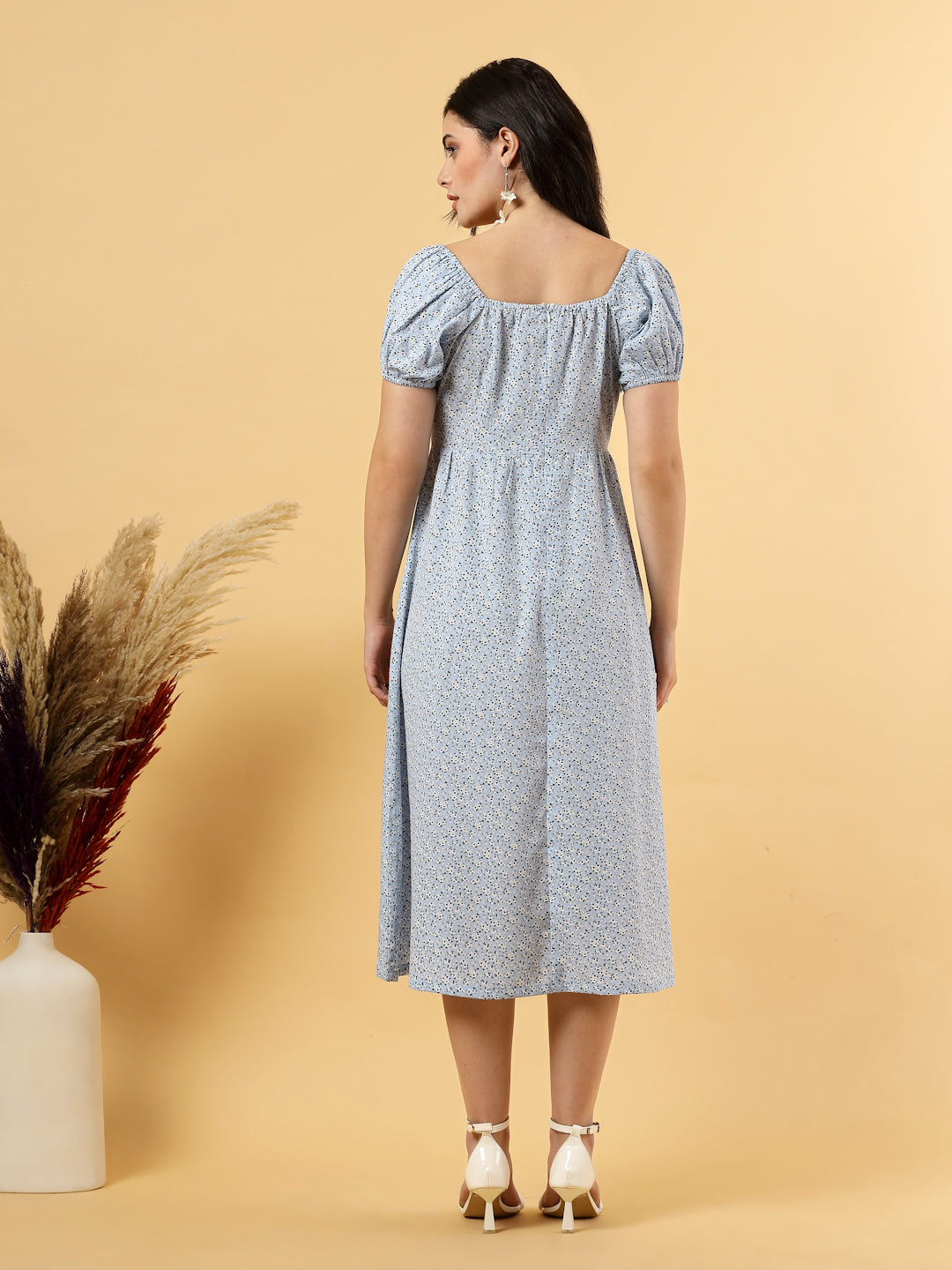 Sunshine in a dress! This flirty A-Line midi boasts a ruched bust, square neck, empire waist, and a flattering front slit – all adorned with gorgeous summer prints. 
Zip Closure at back.