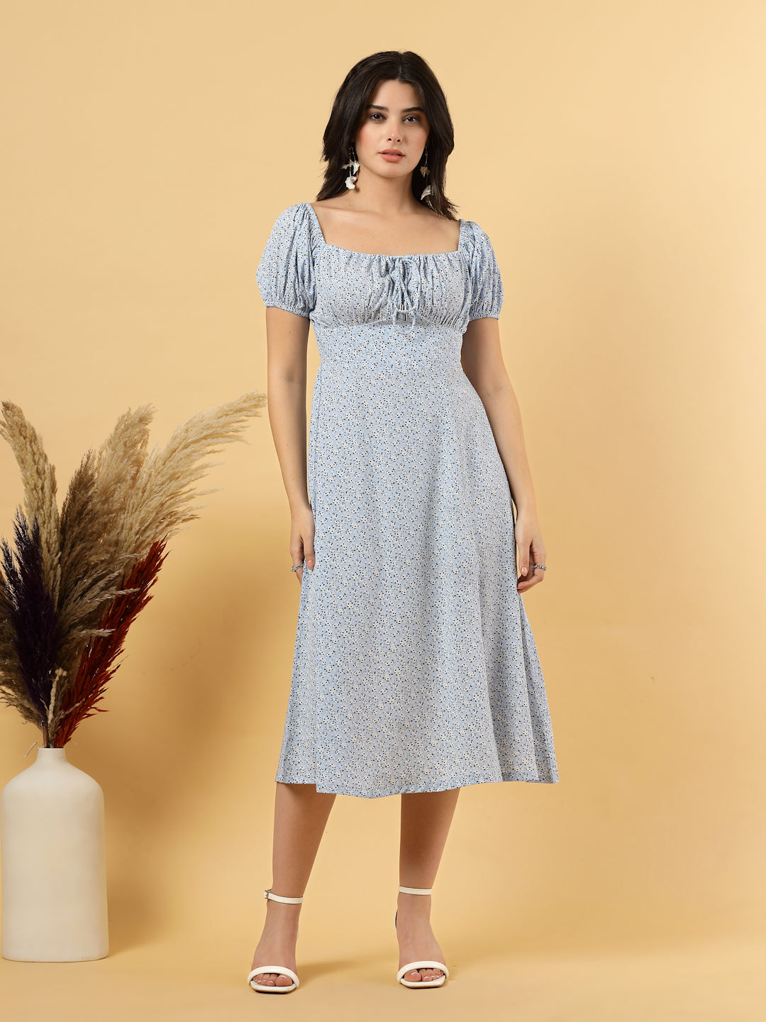 Sunshine in a dress! This flirty A-Line midi boasts a ruched bust, square neck, empire waist, and a flattering front slit – all adorned with gorgeous summer prints. 
Zip Closure at back.