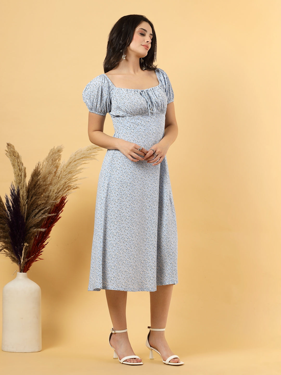 Sunshine in a dress! This flirty A-Line midi boasts a ruched bust, square neck, empire waist, and a flattering front slit – all adorned with gorgeous summer prints. 
Zip Closure at back.