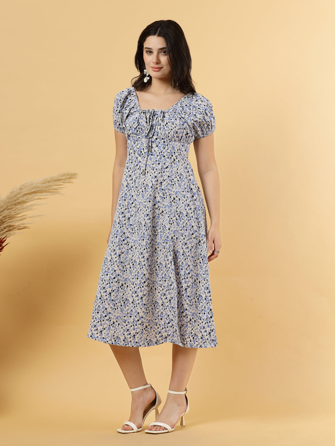 Sunshine in a dress! This flirty A-Line midi boasts a ruched bust, square neck, empire waist, and a flattering front slit – all adorned with gorgeous summer prints.
Zip Closure at back.