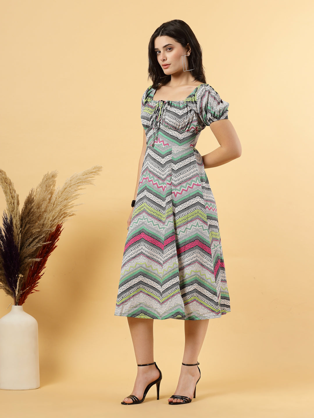 Sunshine in a dress! This flirty A-Line midi boasts a ruched bust, square neck, empire waist, and a flattering front slit – all adorned with gorgeous summer prints. 
Zip Closure at back.