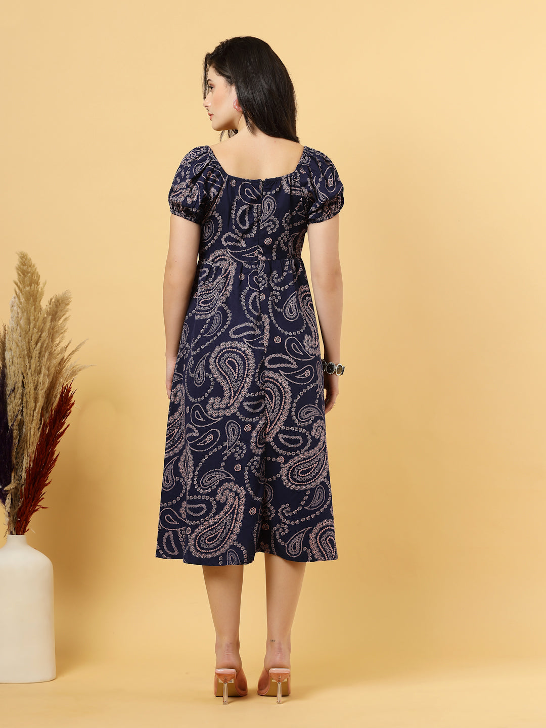 Sunshine in a dress! This flirty A-Line midi boasts a ruched bust, square neck, empire waist, and a flattering front slit – all adorned with gorgeous summer prints. 
Zip Closure at back.