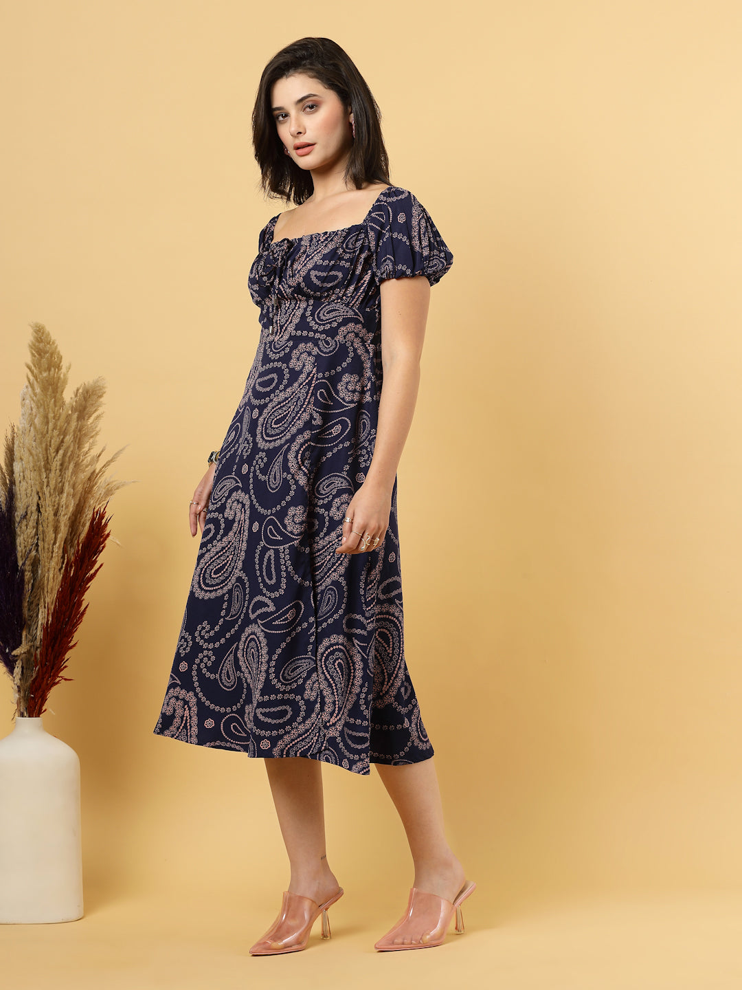 Sunshine in a dress! This flirty A-Line midi boasts a ruched bust, square neck, empire waist, and a flattering front slit – all adorned with gorgeous summer prints. 
Zip Closure at back.