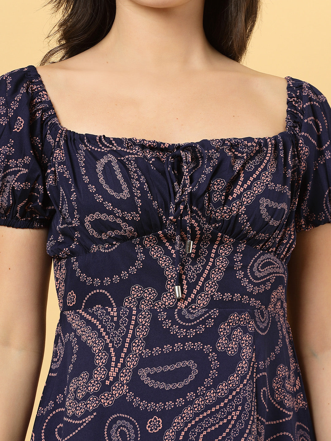 Sunshine in a dress! This flirty A-Line midi boasts a ruched bust, square neck, empire waist, and a flattering front slit – all adorned with gorgeous summer prints.
Zip Closure at back.