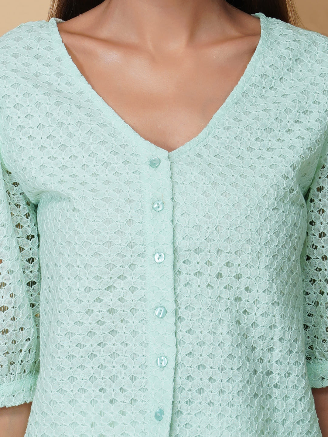 The Green Color Jacquard Mesh Women Top is a versatile and stylish piece of clothing that is perfect for both formal and casual occasions. The top features a classic V-neck design that is flattering for all body types, and it is adorned with a row of front buttons that add a touch of elegance and sophistication to the overall look. Made from good-quality jacquard mesh fabric, this top is lightweight, breathable, and comfortable to wear all day long.