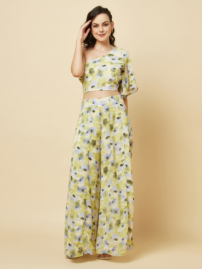 Green floral printed palazzo with one shoulder crop top co-ords for women is a stylish and comfortable outfit choice. The palazzo pants feature a wide-leg cut, providing ease of movement and comfort. The green floral print adds a pop of color and a touch of femininity to the outfit. The one-shoulder crop top is a trendy and flattering choice, showing off the shoulders and adding a touch of elegance to the look. The co-ord set is perfect for a variety of occasions, from casual outings to dressy events. 