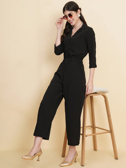 Get ready to make a bold statement with our black formal jumpsuit for women! Tailored in crepe, it features a coat collar with front buttoning and elasticated waist and two side pockets to slip in your essentials. This elegant piece combines sleekness and sophistication, perfect for official and casual wear.