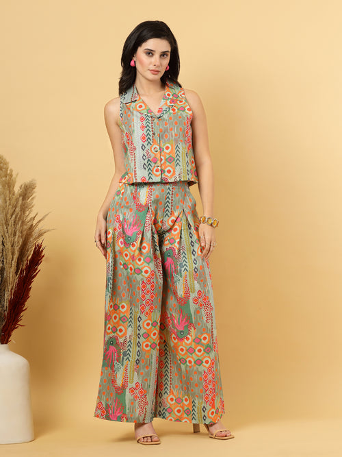 Elevate your ethnic style with this chic 2-piece co-ordinate set for women. The sleeveless top features a beautiful ethnic print with a tailored collar neck and a front button closure for a polished look. Paired with wide-leg pants designed with an elasticated waist, front pleats, and two handy side pockets—this set combines comfort with contemporary flair. Perfect for festive outings or casual gatherings.