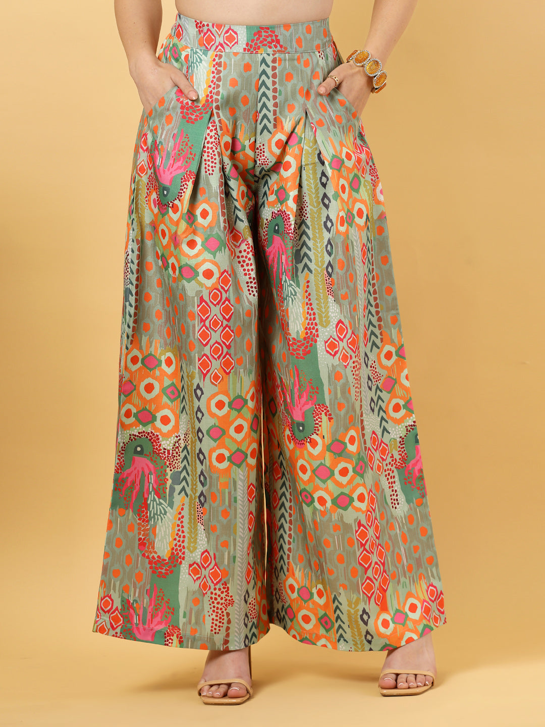 Elevate your ethnic style with this chic 2-piece co-ordinate set for women. The sleeveless top features a beautiful ethnic print with a tailored collar neck and a front button closure for a polished look. Paired with wide-leg pants designed with an elasticated waist, front pleats, and two handy side pockets—this set combines comfort with contemporary flair. Perfect for festive outings or casual gatherings.