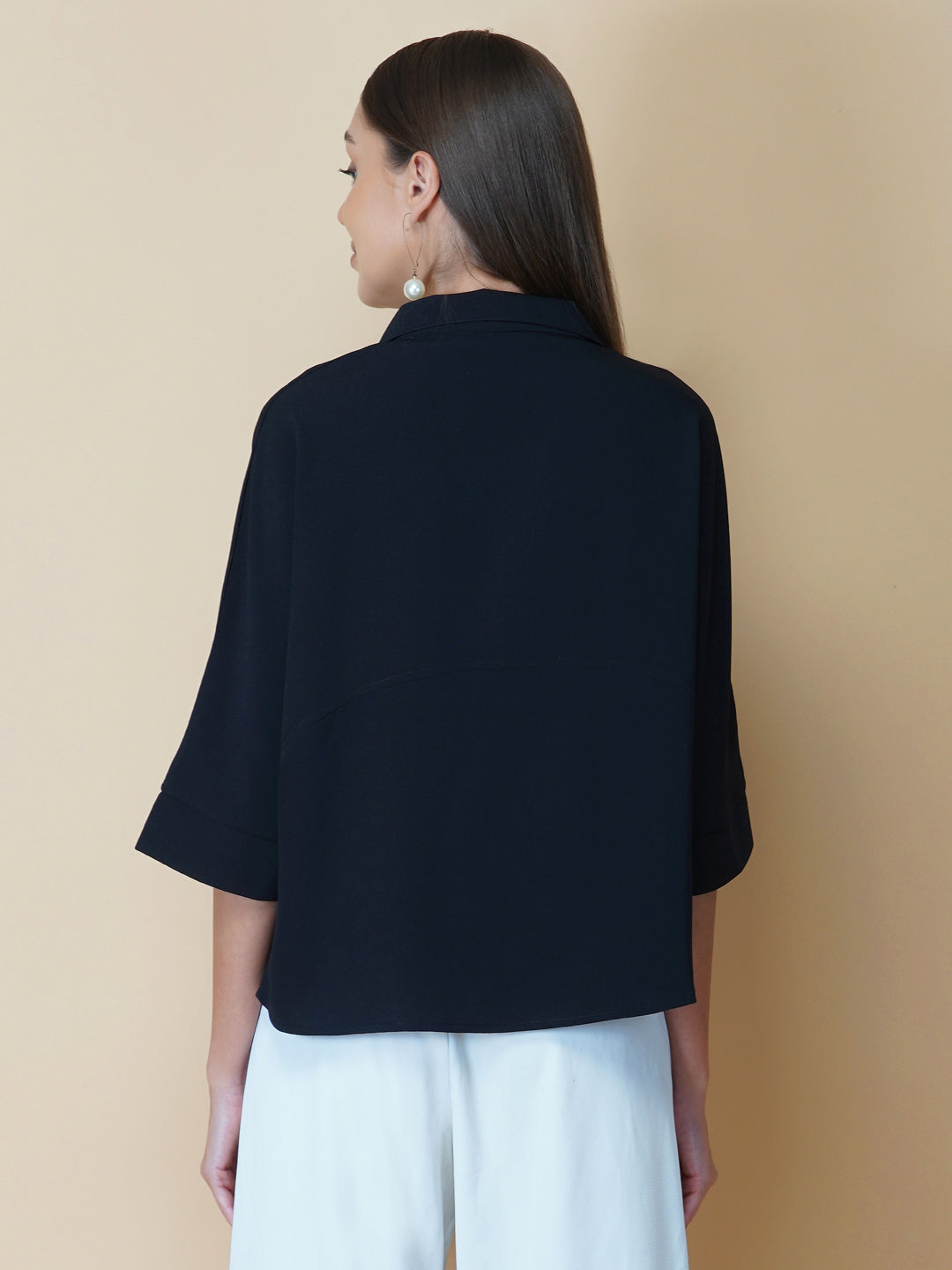 Black oversized women's shirt is a loose-fitting garment designed for a comfortable and relaxed fit. This type of shirt typically features a classic button-up front and a pointed collar, as well as long sleeves that can be rolled up for a more casual look.  The black color adds a touch of sophistication to the overall appearance of the shirt, making it suitable for a variety of occasions. It is made from soft, breathable fabric that drapes gently over the body, providing ample room for movement.