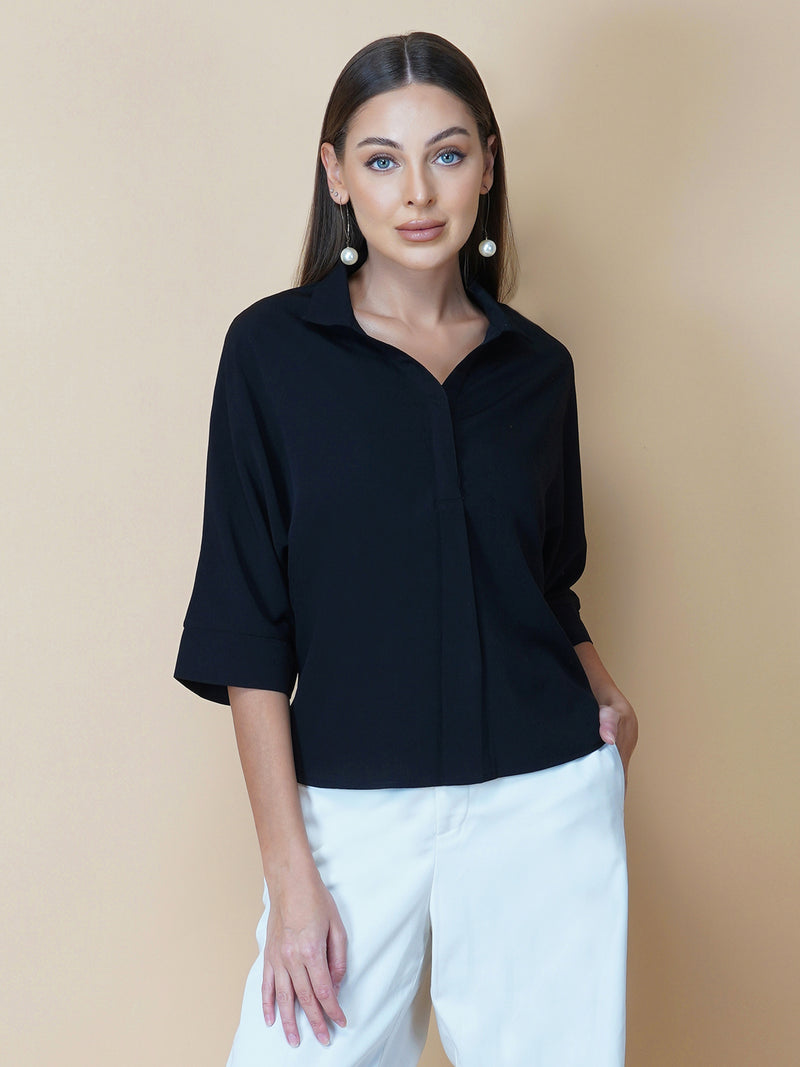 Black oversized women's shirt is a loose-fitting garment designed for a comfortable and relaxed fit. This type of shirt typically features a classic button-up front and a pointed collar, as well as long sleeves that can be rolled up for a more casual look.  The black color adds a touch of sophistication to the overall appearance of the shirt, making it suitable for a variety of occasions. It is made from soft, breathable fabric that drapes gently over the body, providing ample room for movement.