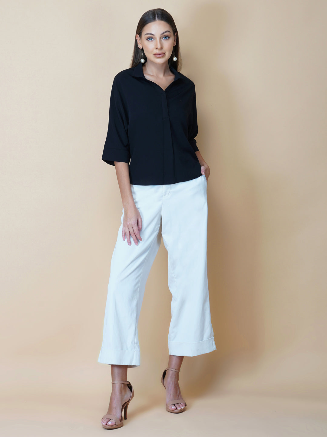Black oversized women's shirt is a loose-fitting garment designed for a comfortable and relaxed fit. This type of shirt typically features a classic button-up front and a pointed collar, as well as long sleeves that can be rolled up for a more casual look.  The black color adds a touch of sophistication to the overall appearance of the shirt, making it suitable for a variety of occasions. It is made from soft, breathable fabric that drapes gently over the body, providing ample room for movement.