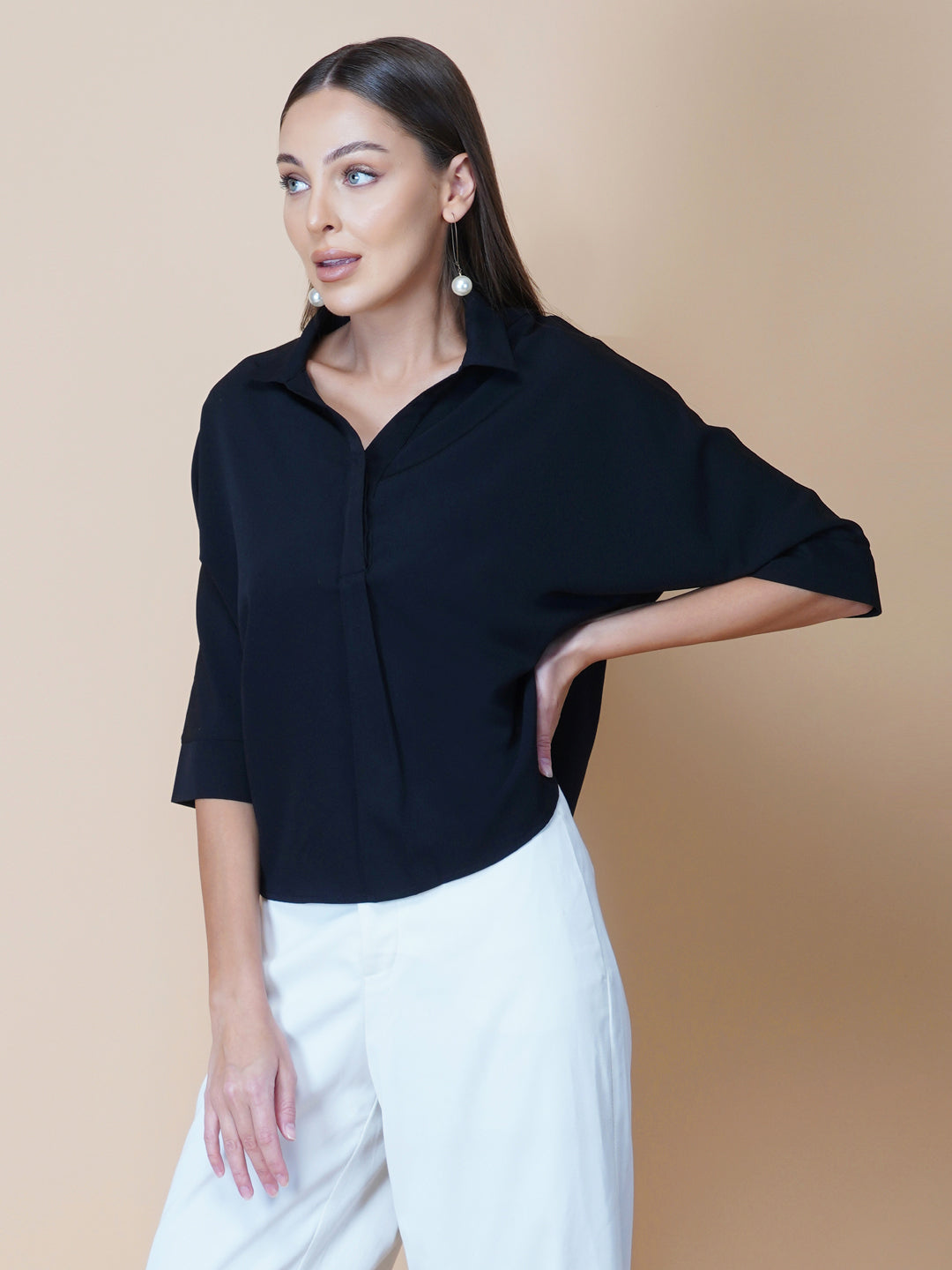 Black oversized women's shirt is a loose-fitting garment designed for a comfortable and relaxed fit. This type of shirt typically features a classic button-up front and a pointed collar, as well as long sleeves that can be rolled up for a more casual look.  The black color adds a touch of sophistication to the overall appearance of the shirt, making it suitable for a variety of occasions. It is made from soft, breathable fabric that drapes gently over the body, providing ample room for movement.