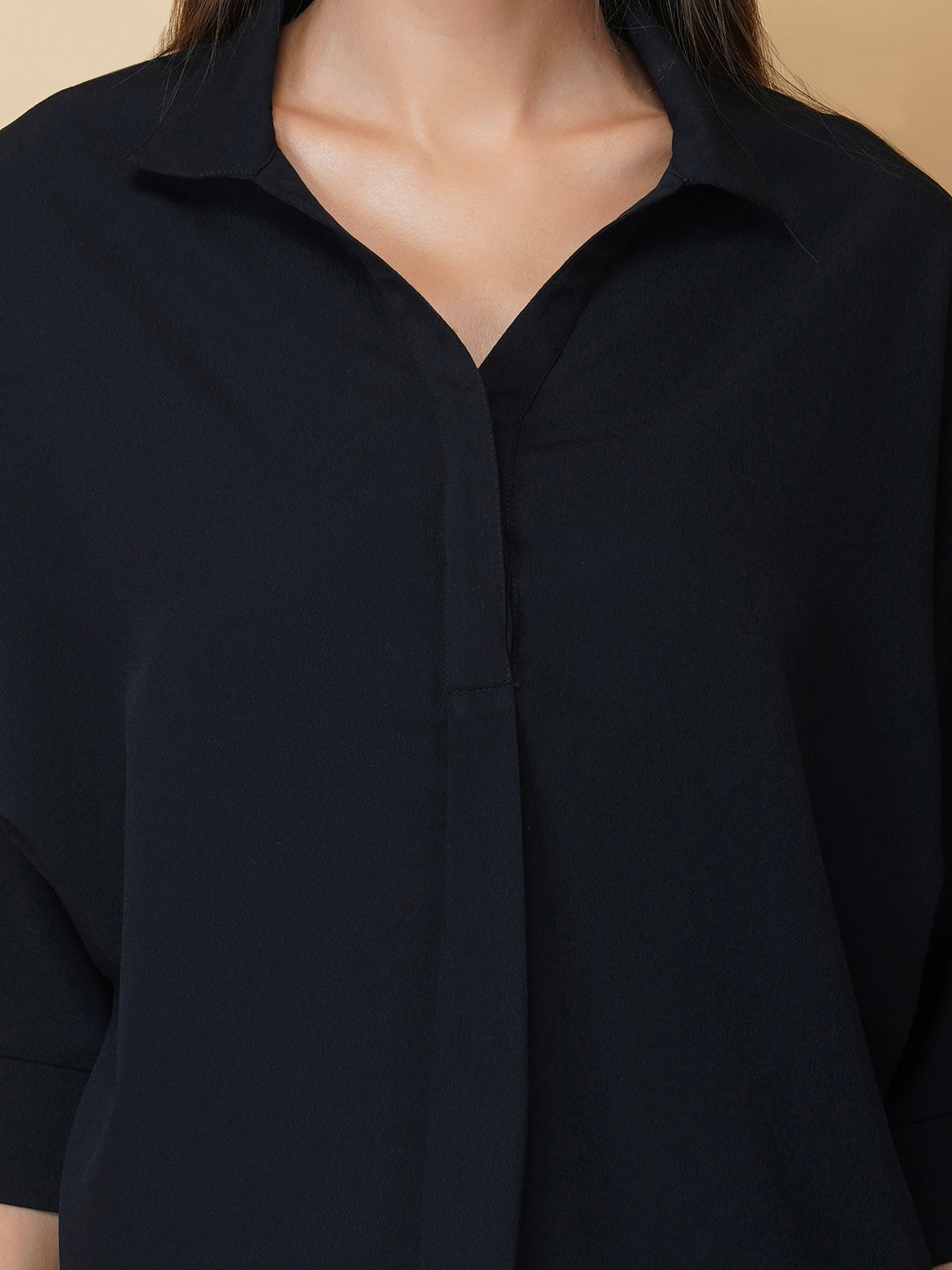 Black oversized women's shirt is a loose-fitting garment designed for a comfortable and relaxed fit. This type of shirt typically features a classic button-up front and a pointed collar, as well as long sleeves that can be rolled up for a more casual look.  The black color adds a touch of sophistication to the overall appearance of the shirt, making it suitable for a variety of occasions. It is made from soft, breathable fabric that drapes gently over the body, providing ample room for movement.