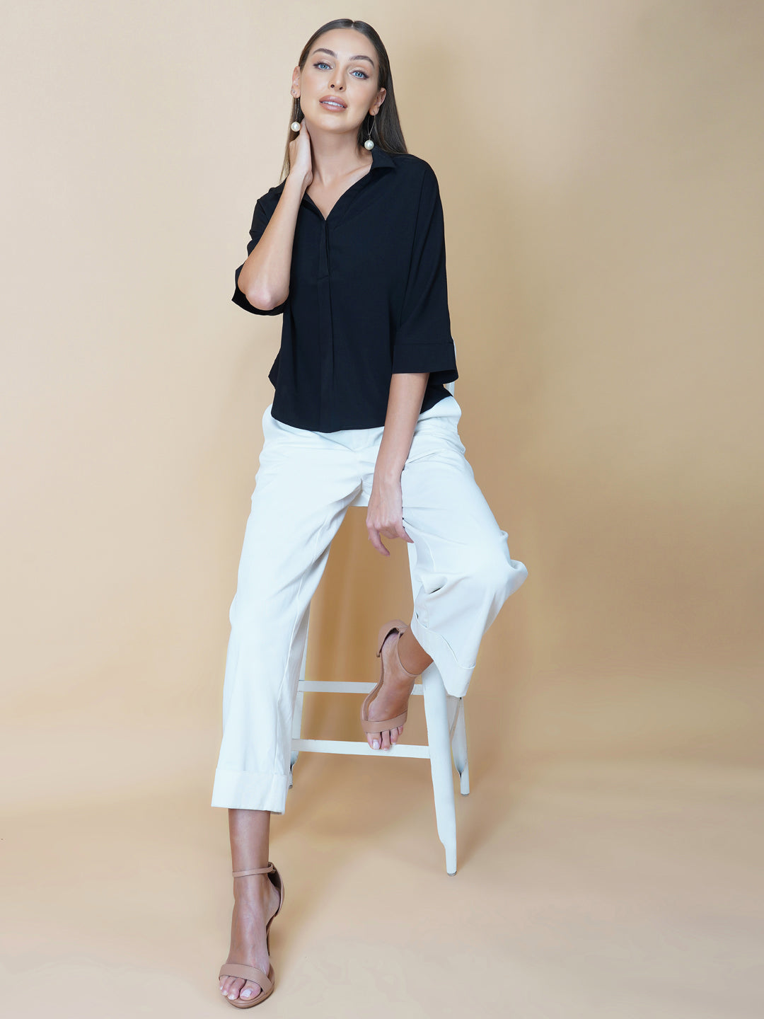 Black oversized women's shirt is a loose-fitting garment designed for a comfortable and relaxed fit. This type of shirt typically features a classic button-up front and a pointed collar, as well as long sleeves that can be rolled up for a more casual look.  The black color adds a touch of sophistication to the overall appearance of the shirt, making it suitable for a variety of occasions. It is made from soft, breathable fabric that drapes gently over the body, providing ample room for movement.