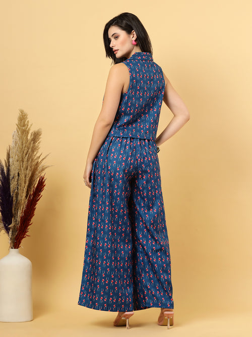 Elevate your ethnic style with this chic 2-piece co-ordinate set for women. The sleeveless top features a beautiful ethnic print with a tailored collar neck and a front button closure for a polished look. Paired with wide-leg pants designed with an elasticated waist, front pleats, and two handy side pockets—this set combines comfort with contemporary flair. Perfect for festive outings or casual gatherings.