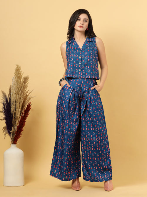 Elevate your ethnic style with this  Blue Colour chic 2-piece co-ordinate set for women. The sleeveless top features a beautiful ethnic print with a tailored collar neck and a front button closure for a polished look. Paired with wide-leg pants designed with an elasticated waist, front pleats, and two handy side pockets—this set combines comfort with contemporary flair. Perfect for festive outings or casual gatherings.
