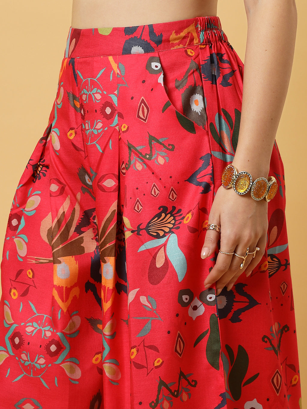 Elevate your ethnic style with this chic 2-piece co-ordinate set for women. The sleeveless top features a beautiful ethnic print with a tailored collar neck and a front button closure for a polished look. Paired with wide-leg pants designed with an elasticated waist, front pleats, and two handy side pockets—this set combines comfort with contemporary flair. Perfect for festive outings or casual gatherings.