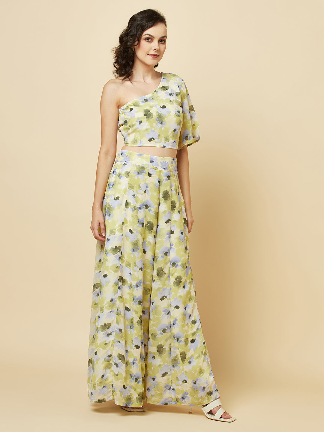 Green floral printed palazzo with one shoulder crop top co-ords for women is a stylish and comfortable outfit choice. The palazzo pants feature a wide-leg cut, providing ease of movement and comfort. The green floral print adds a pop of color and a touch of femininity to the outfit. The one-shoulder crop top is a trendy and flattering choice, showing off the shoulders and adding a touch of elegance to the look. The co-ord set is perfect for a variety of occasions, from casual outings to dressy events. 