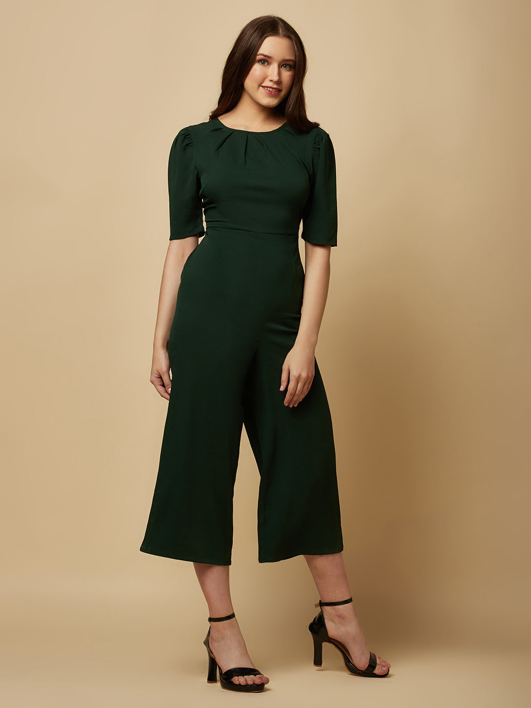 Introducing our stunning Green solid Women Jumpsuit With Back Waist Cut and Draw String, the perfect addition to your wardrobe for a stylish and comfortable look. This jumpsuit features a unique pattern that is sure to turn heads and make you stand out from the crowd.  Crafted from high-quality materials, this jumpsuit is both soft and durable, making it perfect for all-day wear.