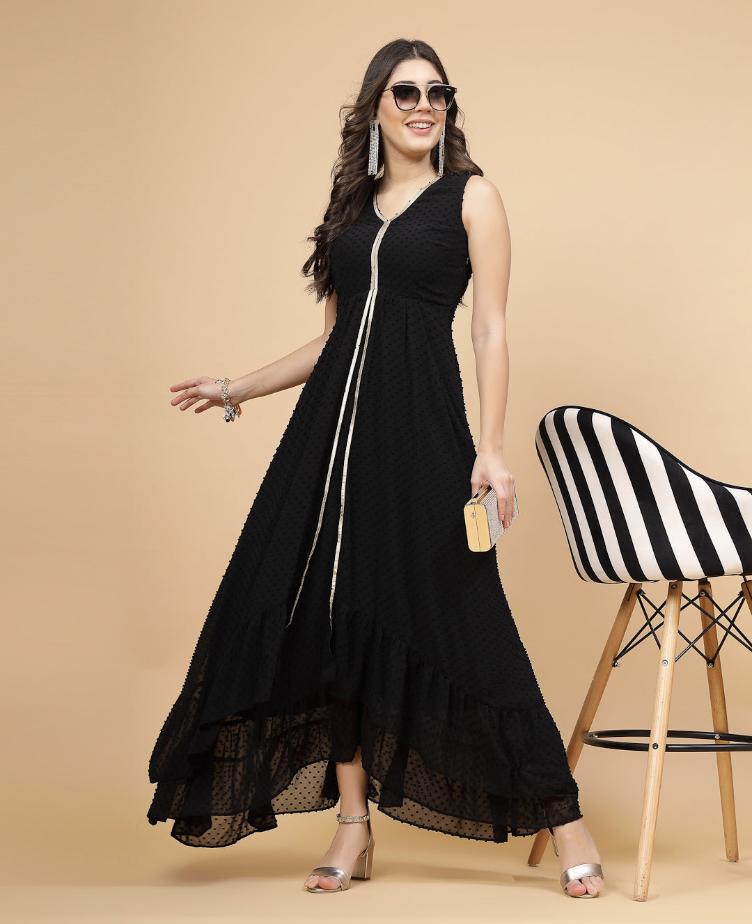High Low Traditional maxi dresses in black color is a trendy and comfortable dress for  women in georgette with Swiss dot texture. Tailored with V-neck and high low pattern. Finished with a zip closure. It comes with a attached lining.