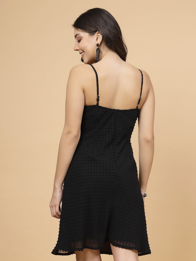 A stylish short Western dress in black color with a zip closure for easy wear. The dress is adorned with ruched bust detailing, adding a fashionable touch. It comes with adjustable shoulder straps for a customizable fit. The presence of an attached lining enhances comfort and coverage, making it a chic and versatile wardrobe choice.