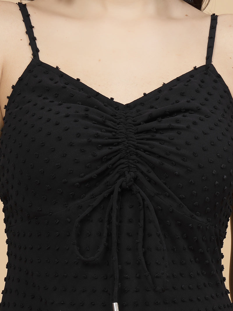 A stylish short Western dress in black color with a zip closure for easy wear. The dress is adorned with ruched bust detailing, adding a fashionable touch. It comes with adjustable shoulder straps for a customizable fit. The presence of an attached lining enhances comfort and coverage, making it a chic and versatile wardrobe choice.