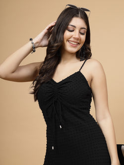 A stylish short Western dress in black color with a zip closure for easy wear. The dress is adorned with ruched bust detailing, adding a fashionable touch. It comes with adjustable shoulder straps for a customizable fit. The presence of an attached lining enhances comfort and coverage, making it a chic and versatile wardrobe choice.