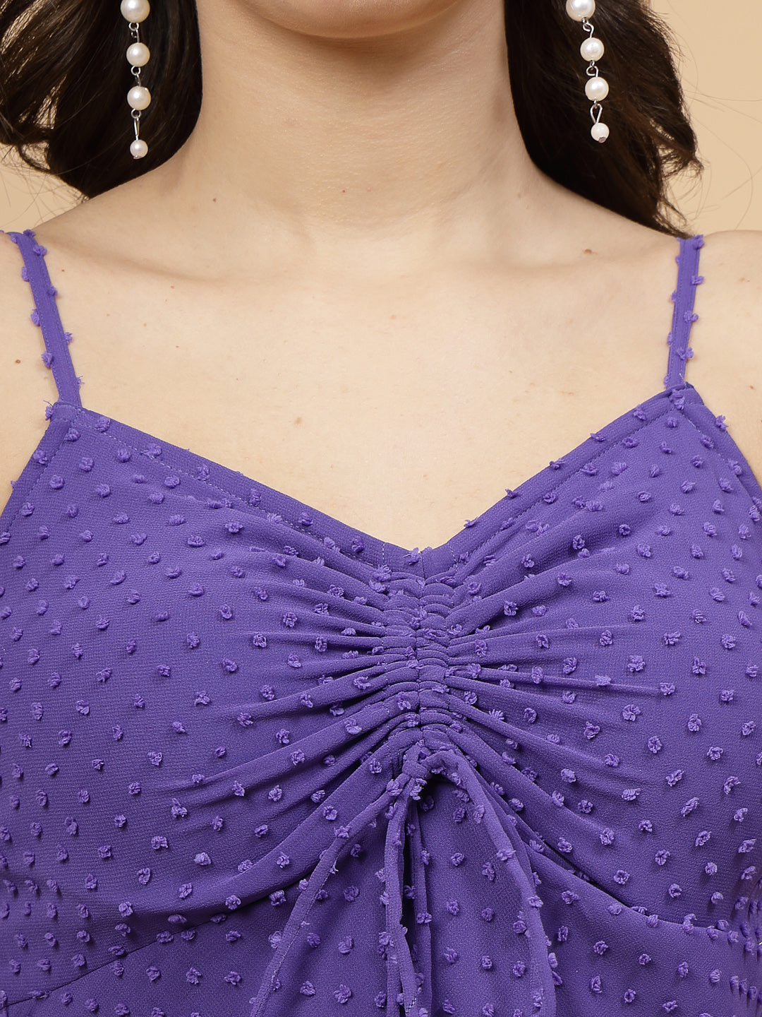 A stylish short Western dress in a Blue color with a zip closure for easy wear. The dress is adorned with ruched bust detailing, adding a fashionable touch. It comes with adjustable shoulder straps for a customizable fit. The presence of an attached lining enhances comfort and coverage, making it a chic and versatile wardrobe choice.