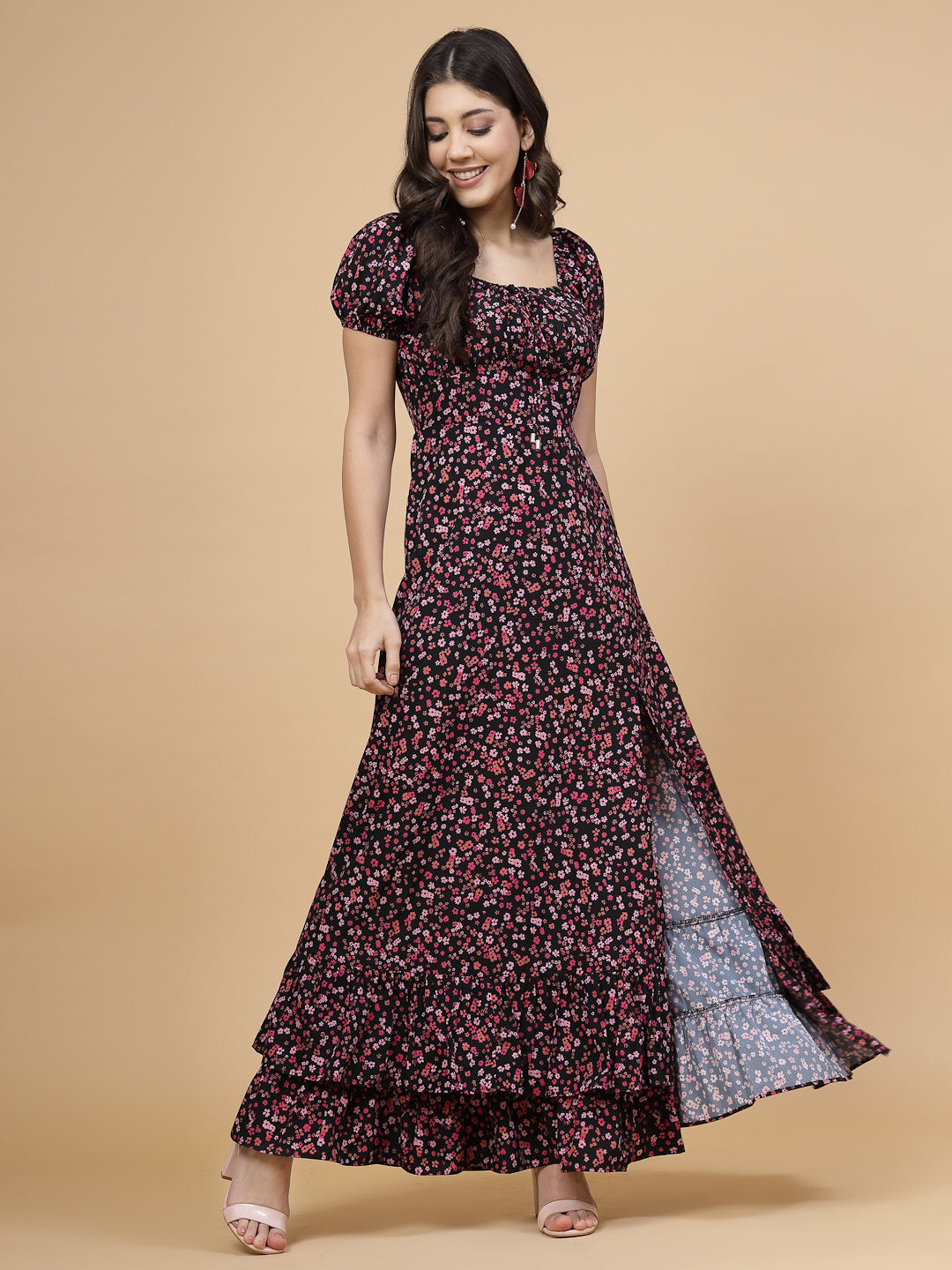 A floor-length casual maxi dress in a vibrant pink color. The dress features ruched bust detailing with a drawstring for a customizable fit. It has elasticated shoulders, creating a comfortable and versatile style. The empire waist accentuates the figure, and a double ruffle adds a touch of flair. A front flare with a slit enhances mobility and style. The dress is secured with a zip closure for easy wear.