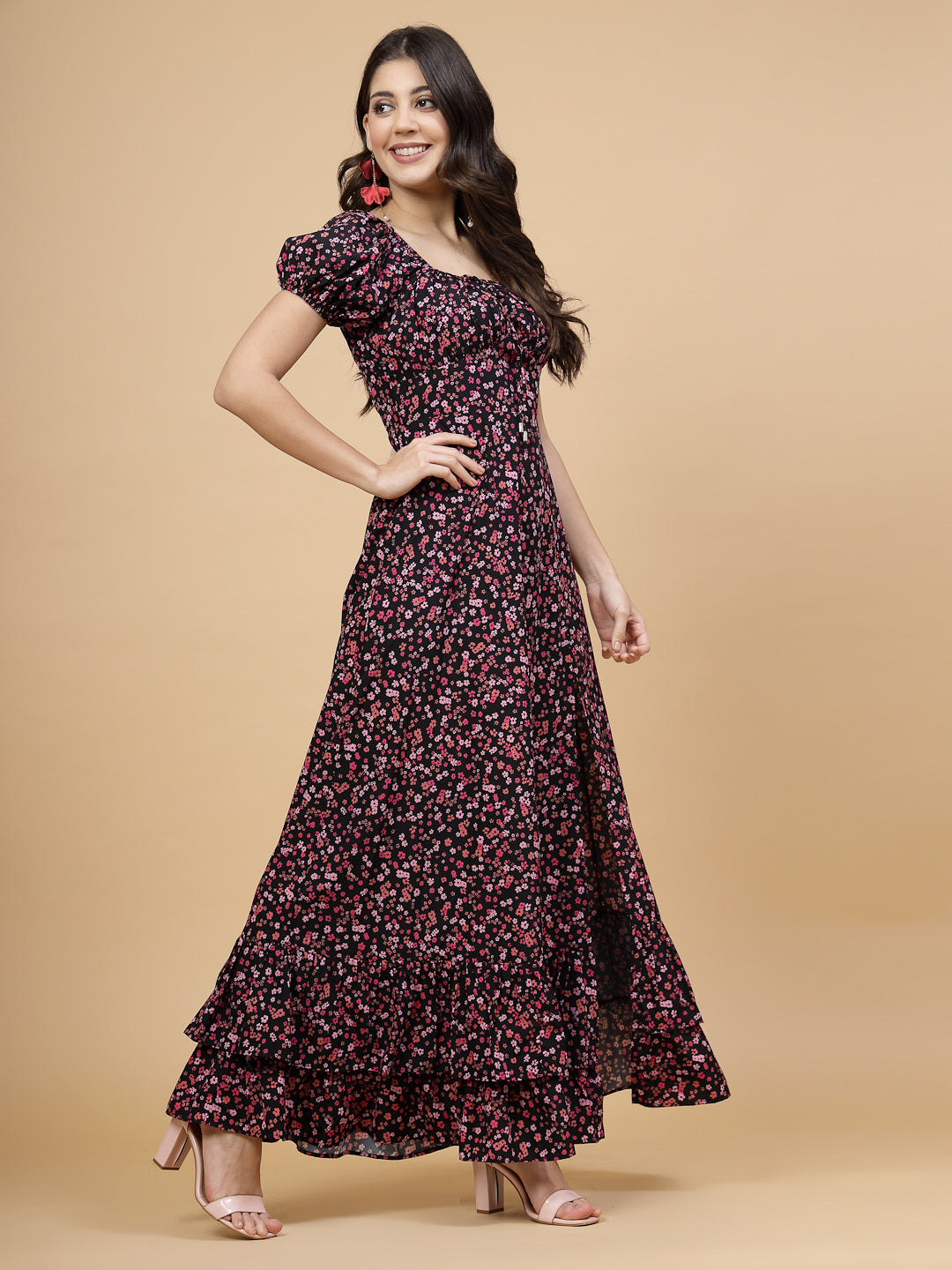 A floor-length casual maxi dress in a vibrant pink color. The dress features ruched bust detailing with a drawstring for a customizable fit. It has elasticated shoulders, creating a comfortable and versatile style. The empire waist accentuates the figure, and a double ruffle adds a touch of flair. A front flare with a slit enhances mobility and style. The dress is secured with a zip closure for easy wear.