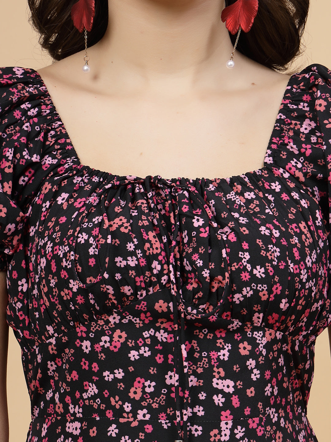 A floor-length casual maxi dress in a vibrant pink color. The dress features ruched bust detailing with a drawstring for a customizable fit. It has elasticated shoulders, creating a comfortable and versatile style. The empire waist accentuates the figure, and a double ruffle adds a touch of flair. A front flare with a slit enhances mobility and style. The dress is secured with a zip closure for easy wear.