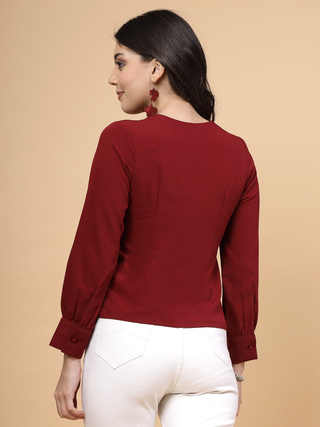 A vibrant red puff sleeve blouse designed for a fashionable look. The blouse features a button closure at the front, allowing for easy wear. With full sleeves, it is a versatile and stylish choice, perfect for pairing with jeans to create a trendy ensemble.