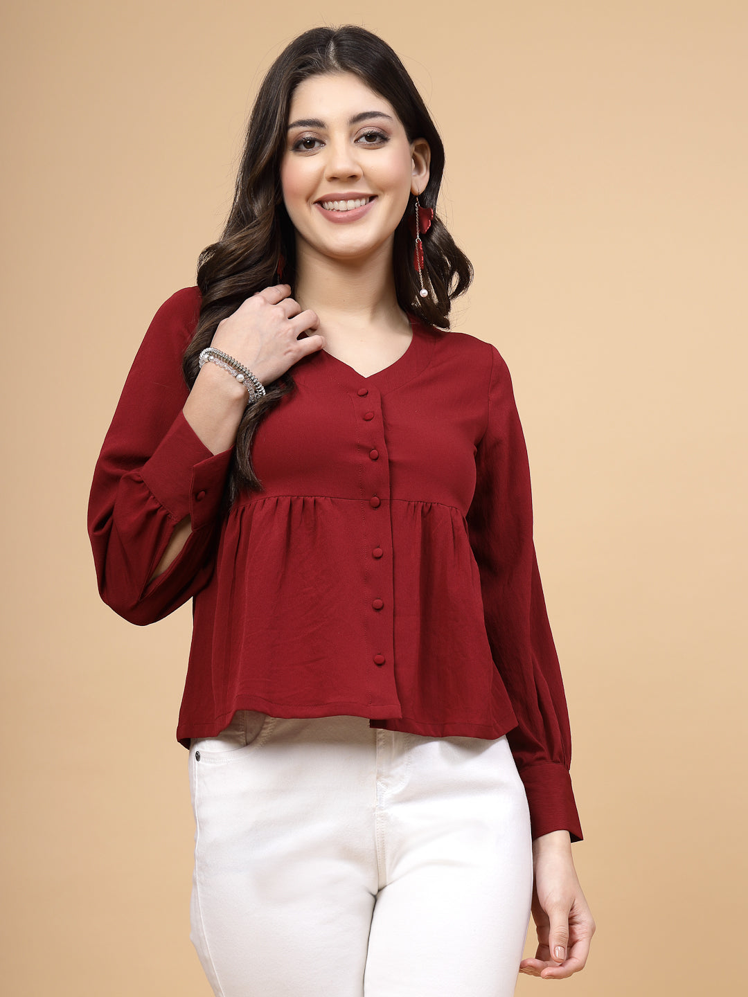 A vibrant red puff sleeve blouse designed for a fashionable look. The blouse features a button closure at the front, allowing for easy wear. With full sleeves, it is a versatile and stylish choice, perfect for pairing with jeans to create a trendy ensemble.