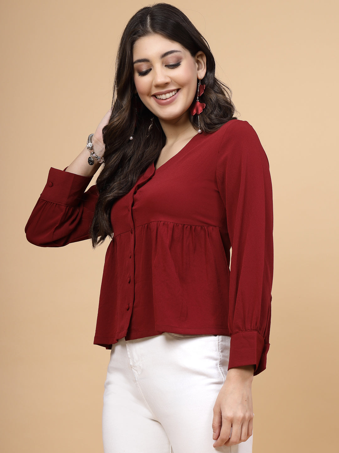 A vibrant red puff sleeve blouse designed for a fashionable look. The blouse features a button closure at the front, allowing for easy wear. With full sleeves, it is a versatile and stylish choice, perfect for pairing with jeans to create a trendy ensemble.