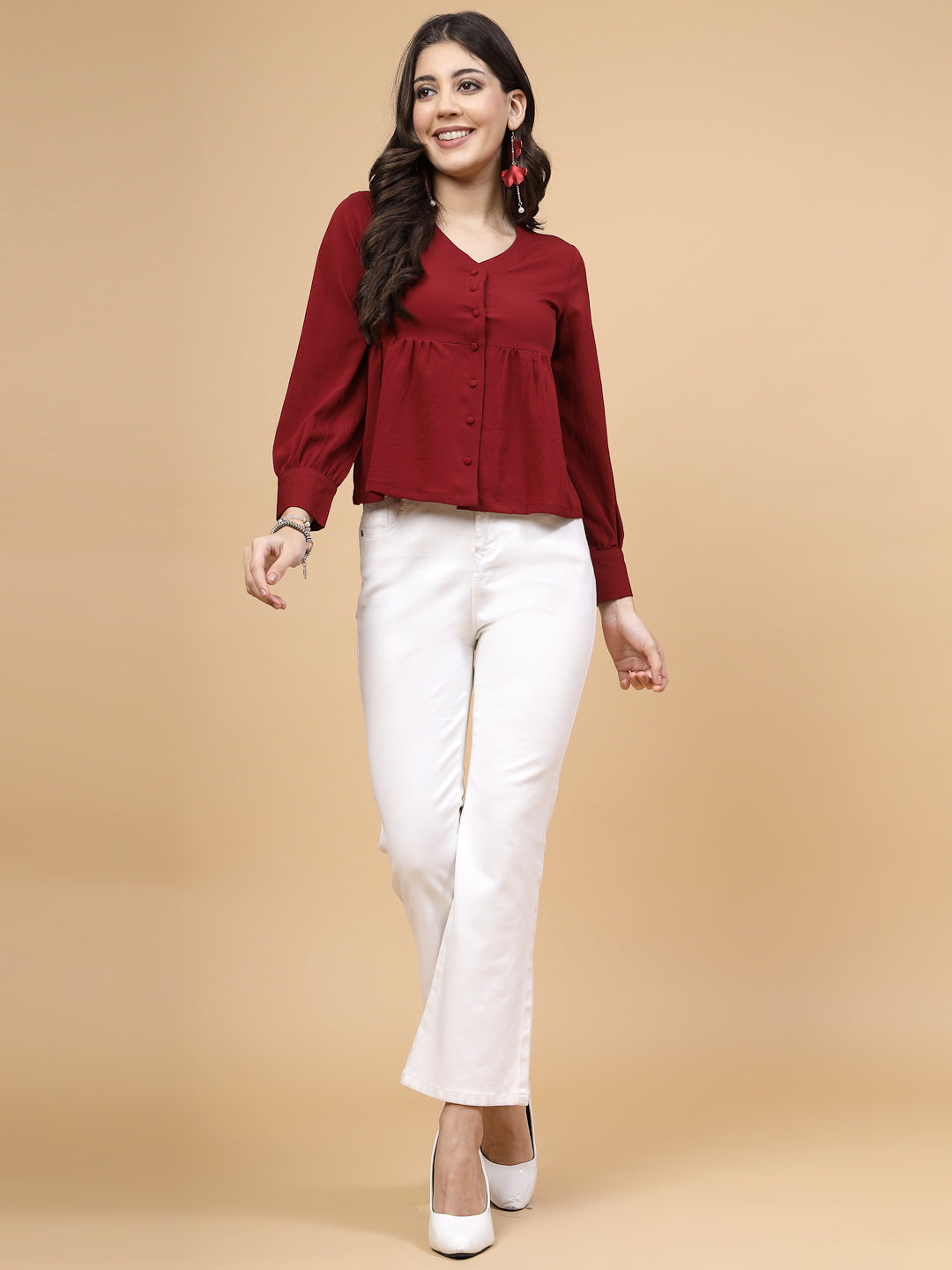 A vibrant red puff sleeve blouse designed for a fashionable look. The blouse features a button closure at the front, allowing for easy wear. With full sleeves, it is a versatile and stylish choice, perfect for pairing with jeans to create a trendy ensemble.
