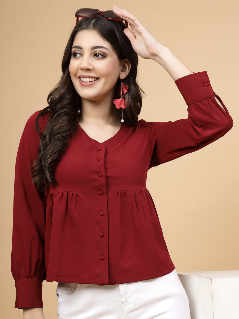 A vibrant red puff sleeve blouse designed for a fashionable look. The blouse features a button closure at the front, allowing for easy wear. With full sleeves, it is a versatile and stylish choice, perfect for pairing with jeans to create a trendy ensemble.