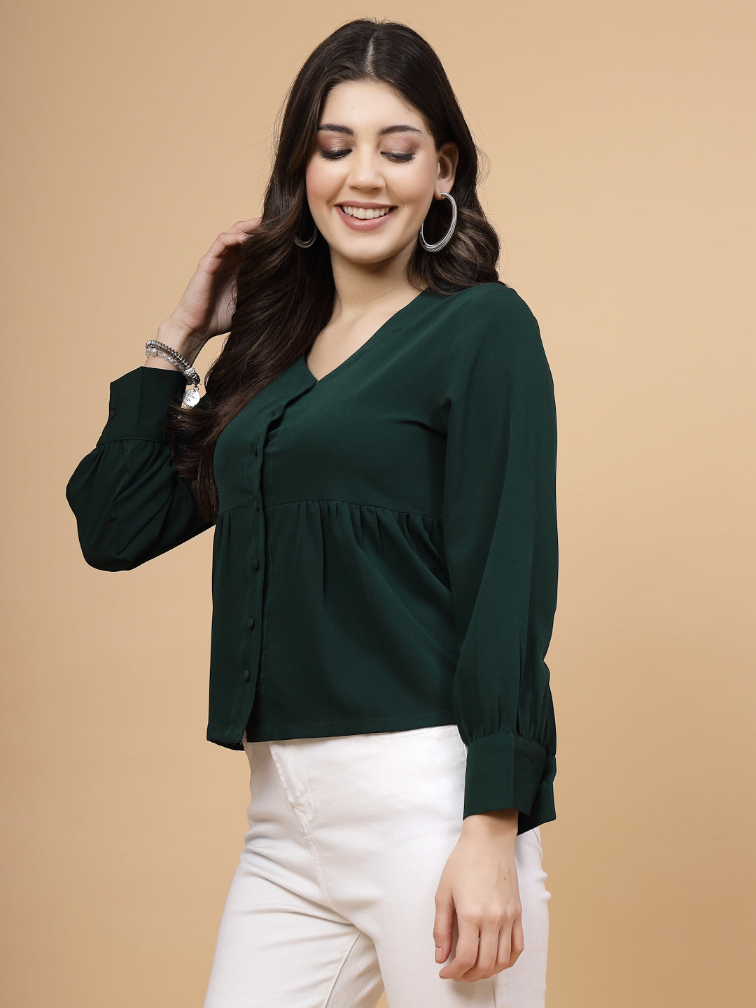 A vibrant green puff sleeve blouse designed for a fashionable look. The blouse features a button closure at the front, allowing for easy wear. With full sleeves, it is a versatile and stylish choice, perfect for pairing with jeans to create a trendy ensemble.