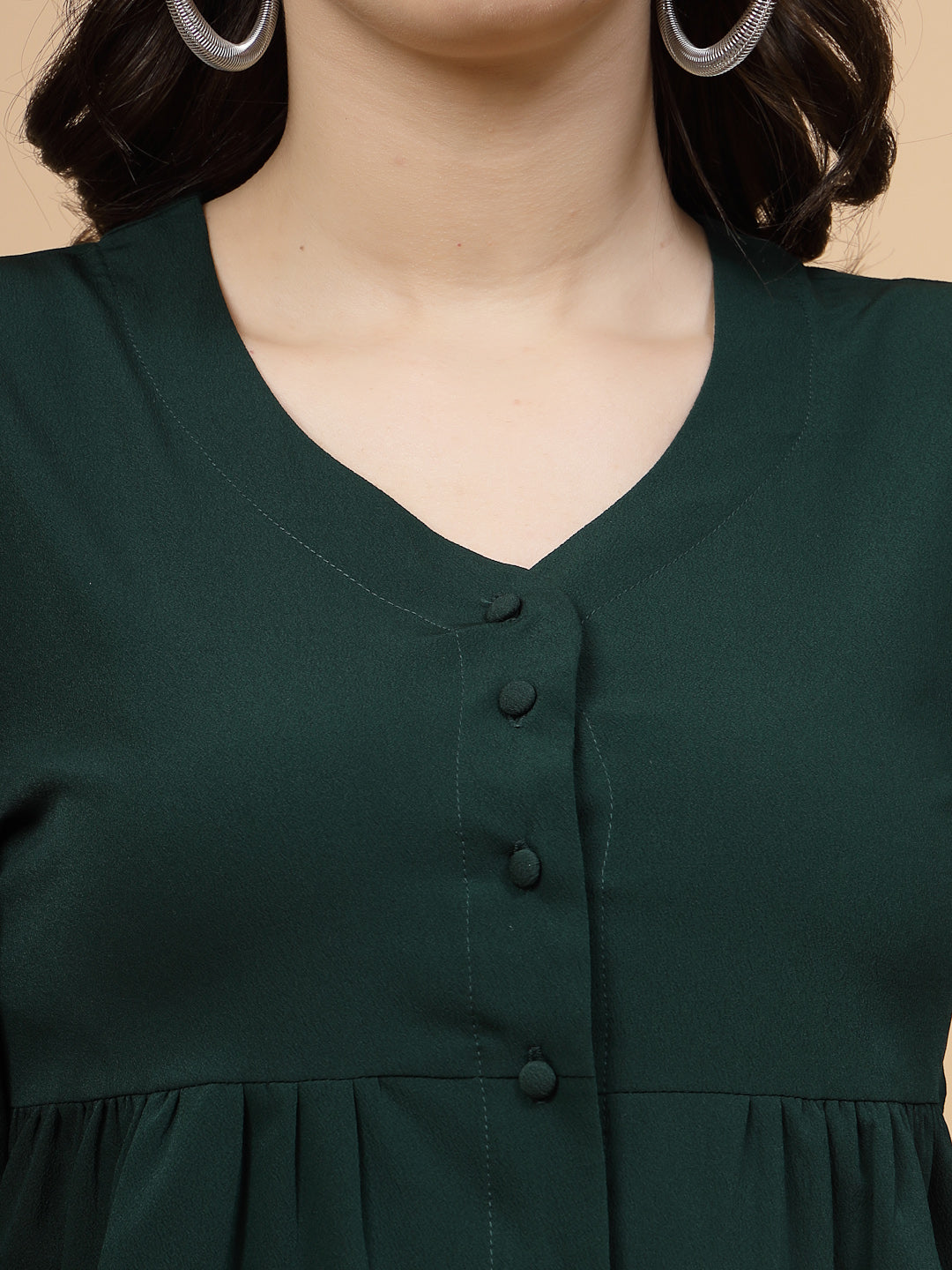 A vibrant green puff sleeve blouse designed for a fashionable look. The blouse features a button closure at the front, allowing for easy wear. With full sleeves, it is a versatile and stylish choice, perfect for pairing with jeans to create a trendy ensemble.