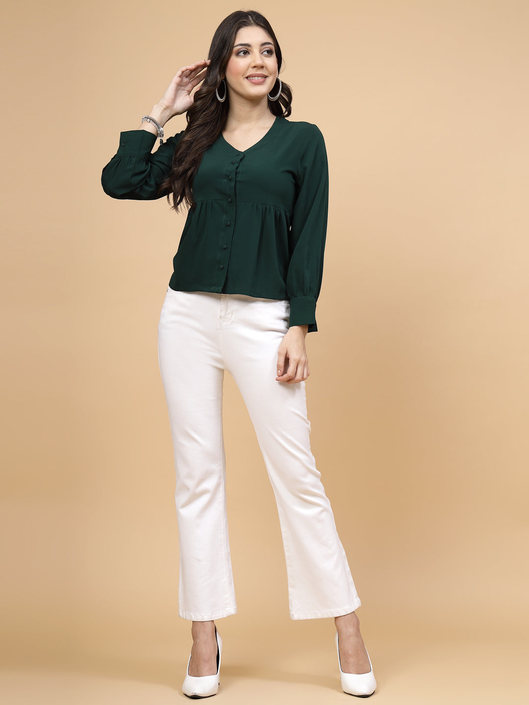 A vibrant green puff sleeve blouse designed for a fashionable look. The blouse features a button closure at the front, allowing for easy wear. With full sleeves, it is a versatile and stylish choice, perfect for pairing with jeans to create a trendy ensemble.