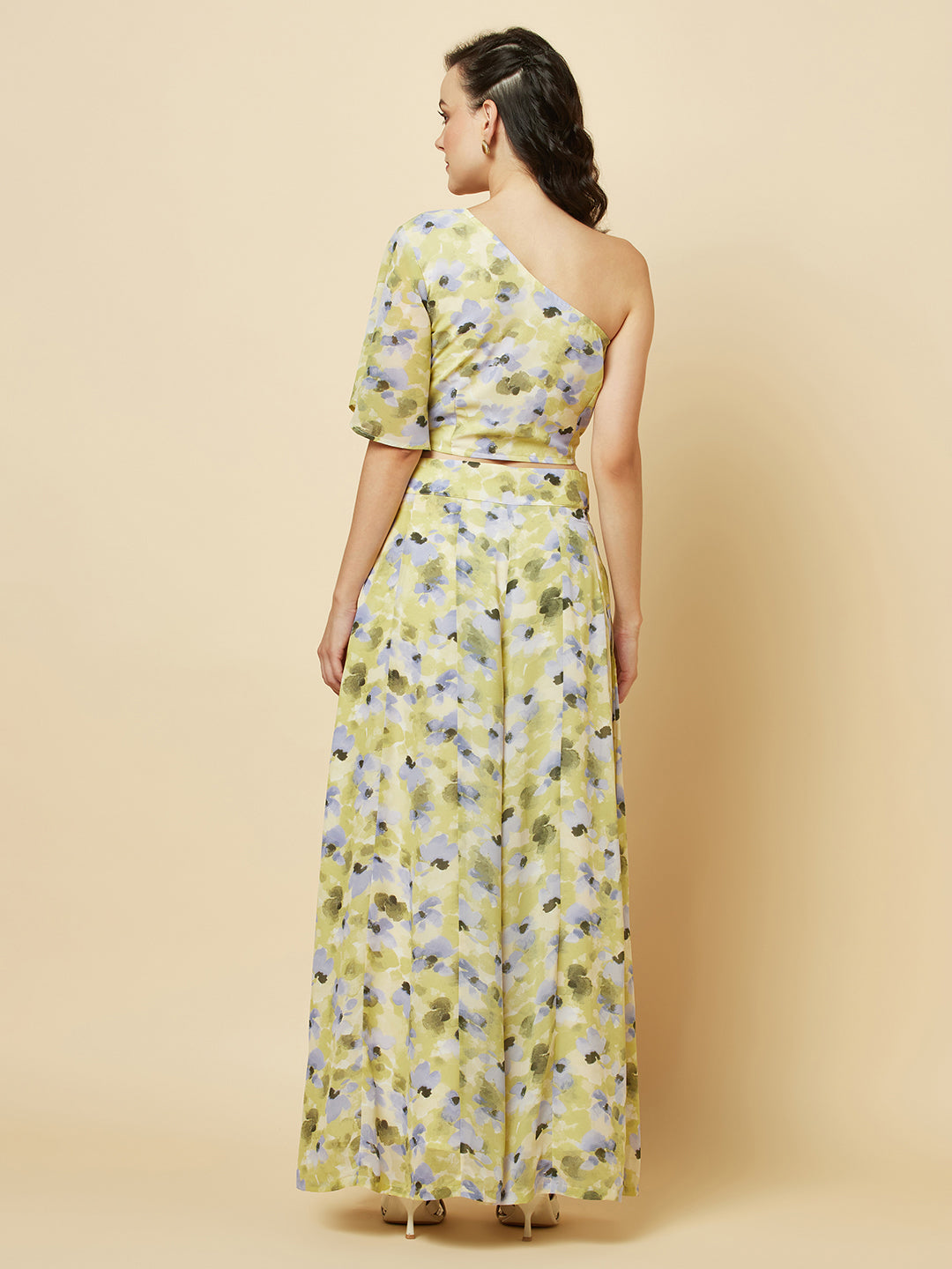 Green floral printed palazzo with one shoulder crop top co-ords for women is a stylish and comfortable outfit choice. The palazzo pants feature a wide-leg cut, providing ease of movement and comfort. The green floral print adds a pop of color and a touch of femininity to the outfit. The one-shoulder crop top is a trendy and flattering choice, showing off the shoulders and adding a touch of elegance to the look. The co-ord set is perfect for a variety of occasions, from casual outings to dressy events. 