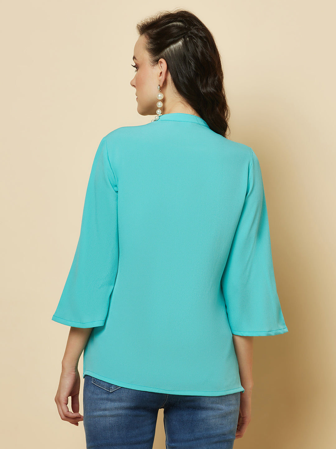 This beautiful top features a vibrant turquoise hue that's perfect for adding a pop of color to any outfit. The pintuck detailing adds a touch of elegance, while the comfortable and breathable fabric ensures that you'll feel great all day long. Whether you're heading to the office or out for a night on the town, this top is sure to turn heads and make you feel confident and beautiful. 