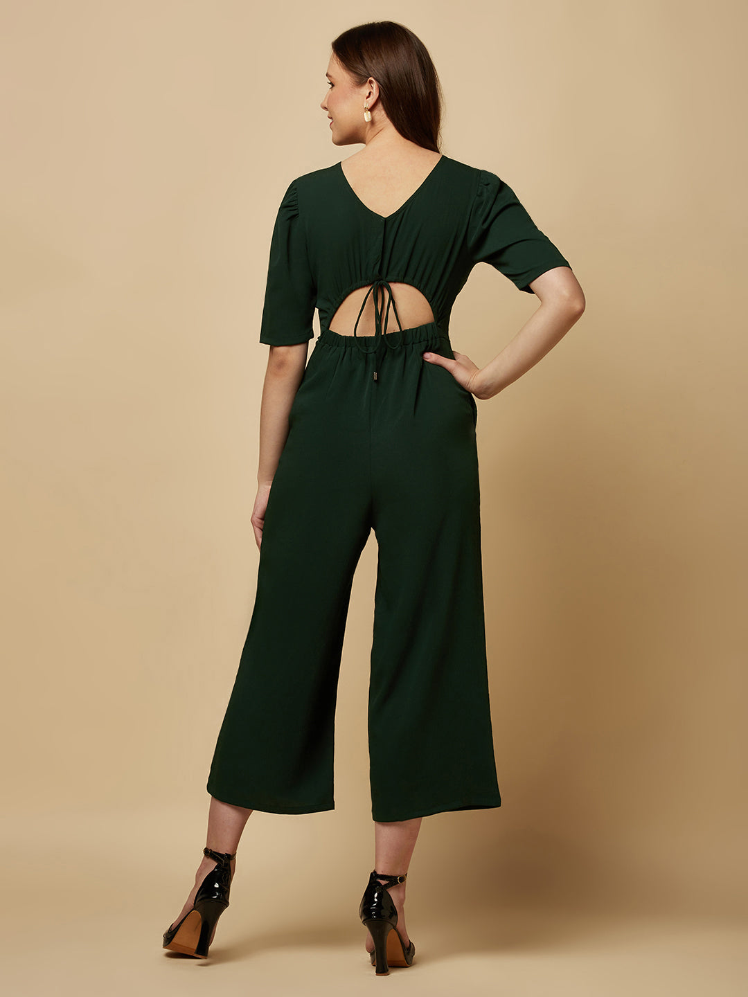 Introducing our stunning Green solid Women Jumpsuit With Back Waist Cut and Draw String, the perfect addition to your wardrobe for a stylish and comfortable look. This jumpsuit features a unique pattern that is sure to turn heads and make you stand out from the crowd.  Crafted from high-quality materials, this jumpsuit is both soft and durable, making it perfect for all-day wear.