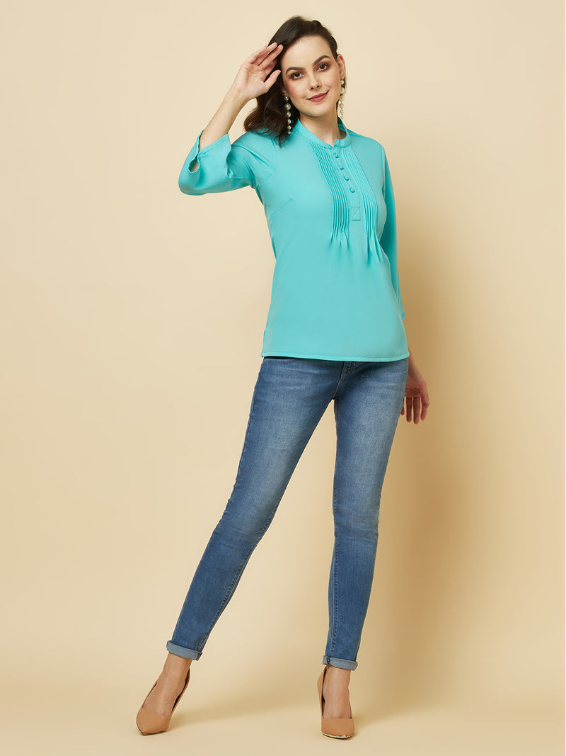 This beautiful top features a vibrant turquoise hue that's perfect for adding a pop of color to any outfit. The pintuck detailing adds a touch of elegance, while the comfortable and breathable fabric ensures that you'll feel great all day long. Whether you're heading to the office or out for a night on the town, this top is sure to turn heads and make you feel confident and beautiful. 