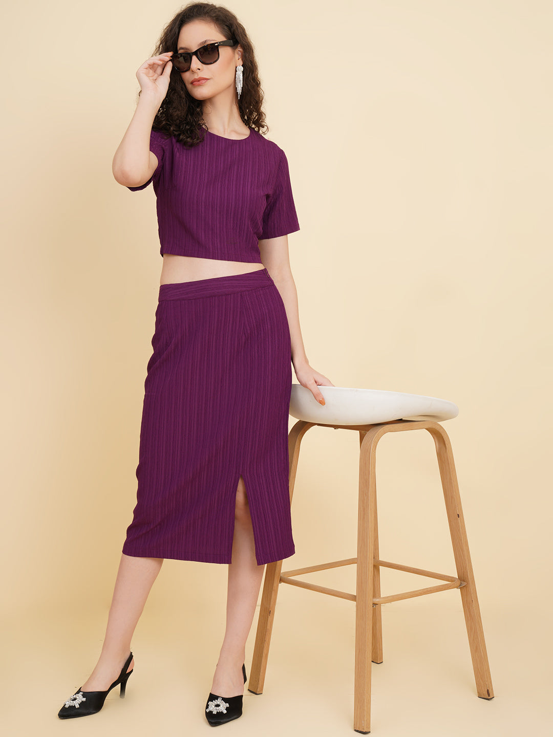 Unleash your inner fashionista with our stunning purple stretchable co-ord set!  Featuring a trendy crop top and a sleek straight skirt.   Colour: Purple Material: Polyester Neck: Round with Keyhole at back Sleeve: Short Top Closure: Button Skirt Closure: Zip