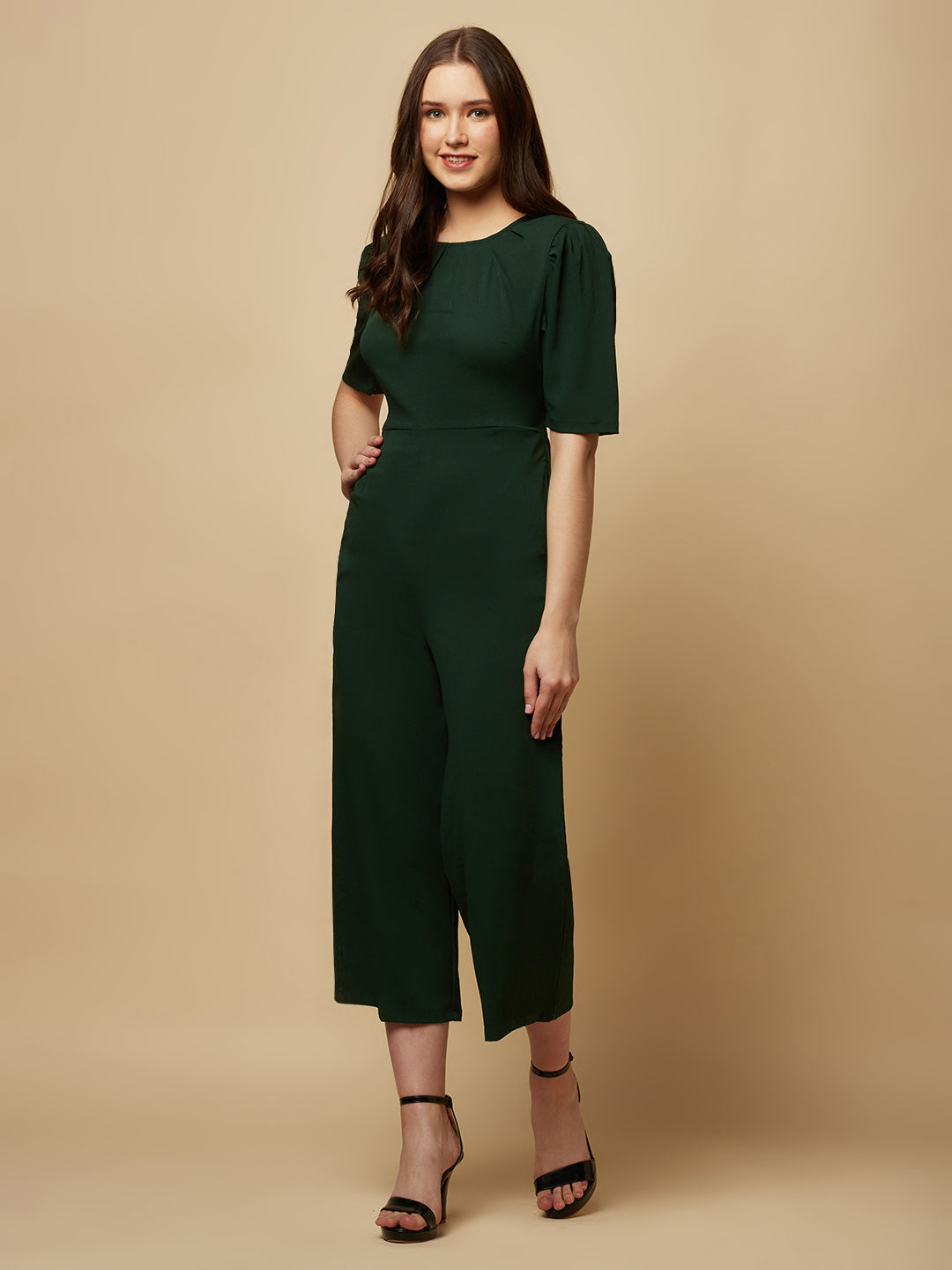 Introducing our stunning Green solid Women Jumpsuit With Back Waist Cut and Draw String, the perfect addition to your wardrobe for a stylish and comfortable look. This jumpsuit features a unique pattern that is sure to turn heads and make you stand out from the crowd.  Crafted from high-quality materials, this jumpsuit is both soft and durable, making it perfect for all-day wear.
