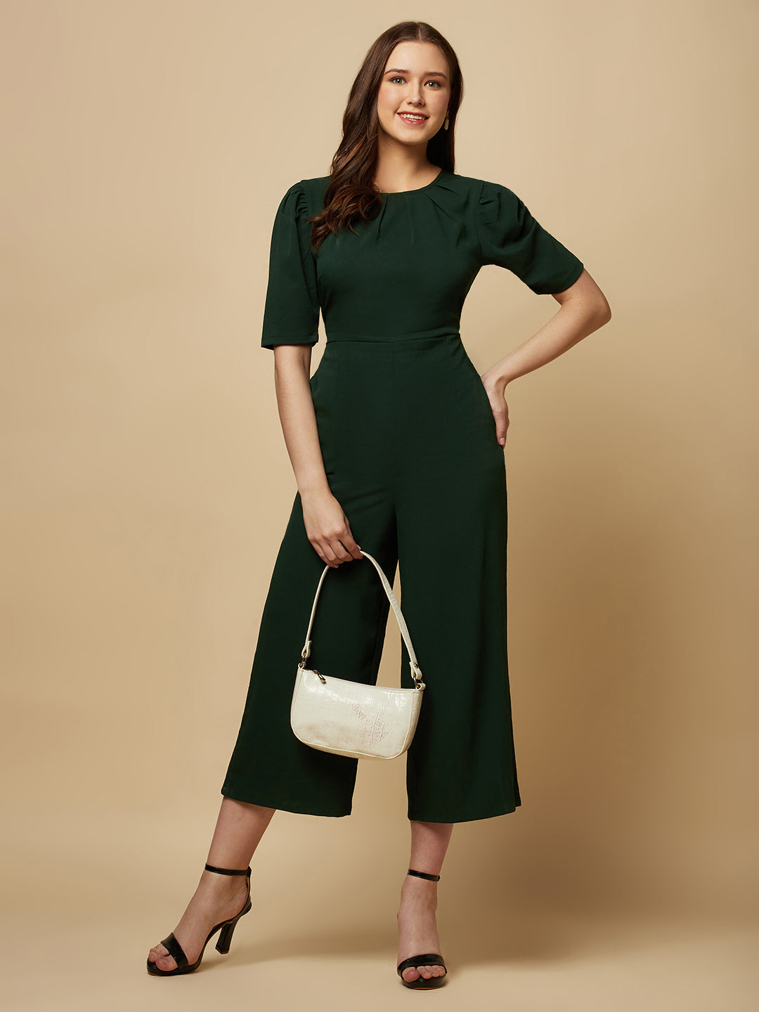 Introducing our stunning Green solid Women Jumpsuit With Back Waist Cut and Draw String, the perfect addition to your wardrobe for a stylish and comfortable look. This jumpsuit features a unique pattern that is sure to turn heads and make you stand out from the crowd.  Crafted from high-quality materials, this jumpsuit is both soft and durable, making it perfect for all-day wear.