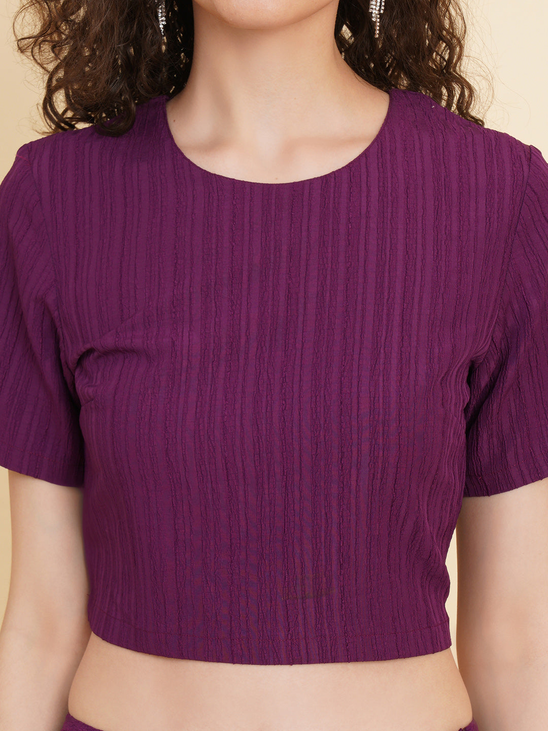 Unleash your inner fashionista with our stunning purple stretchable co-ord set!  Featuring a trendy crop top and a sleek straight skirt.   Colour: Purple Material: Polyester Neck: Round with Keyhole at back Sleeve: Short Top Closure: Button Skirt Closure: Zip