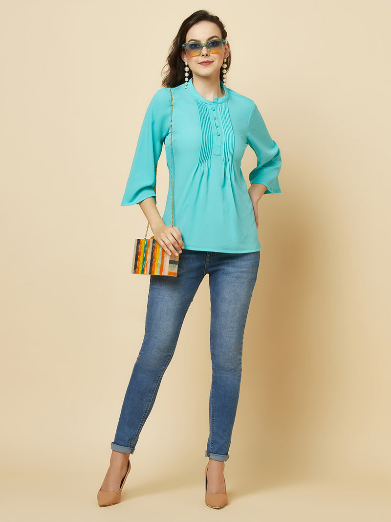 This beautiful top features a vibrant turquoise hue that's perfect for adding a pop of color to any outfit. The pintuck detailing adds a touch of elegance, while the comfortable and breathable fabric ensures that you'll feel great all day long. Whether you're heading to the office or out for a night on the town, this top is sure to turn heads and make you feel confident and beautiful. 